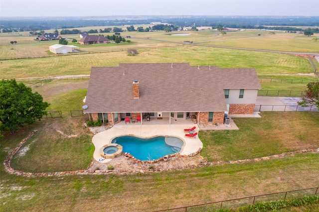 view of pool with a yard, a rural view, and a patio