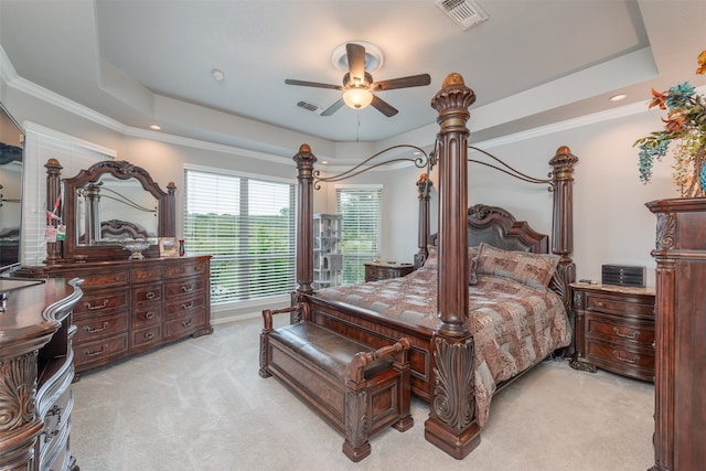 bedroom with a tray ceiling, ceiling fan, and light carpet