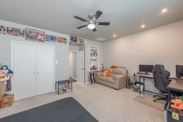 interior space featuring ceiling fan, a closet, and light colored carpet