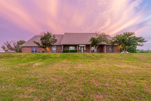 ranch-style house with a lawn