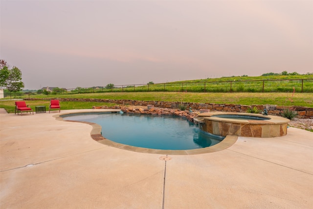 view of pool with an in ground hot tub and a patio