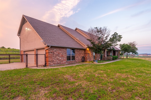 view of front of home featuring a lawn and a garage