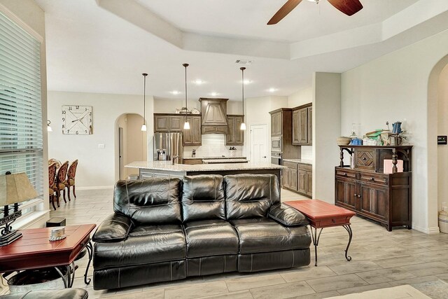 kitchen with a center island, hanging light fixtures, appliances with stainless steel finishes, and tasteful backsplash