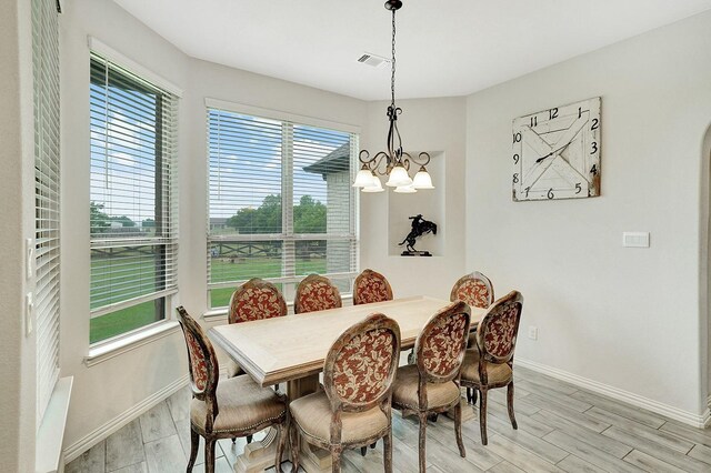 dining room featuring an inviting chandelier and a healthy amount of sunlight