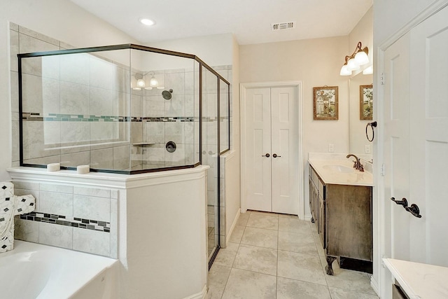 bathroom with shower with separate bathtub, vanity, and tile patterned floors