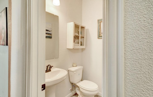 bathroom featuring toilet and sink