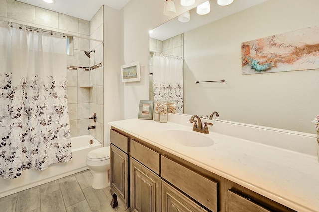 full bathroom with vanity, shower / bath combo, and toilet