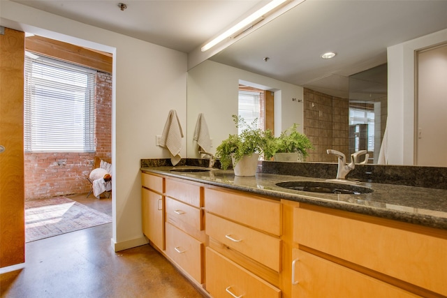 bathroom featuring concrete flooring and vanity