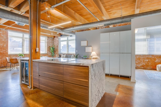 kitchen with brick wall, white cabinets, and wine cooler