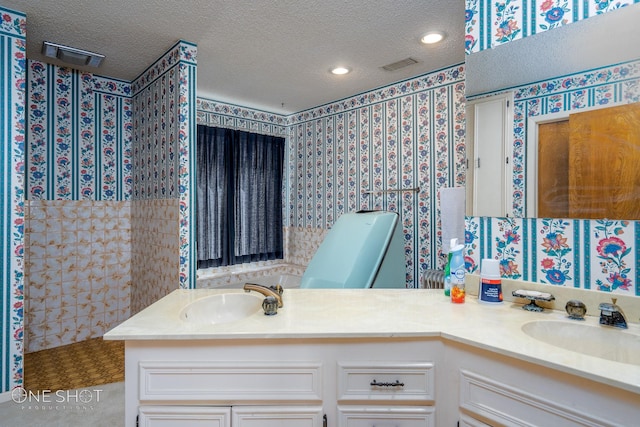 bathroom featuring vanity, a textured ceiling, and tile patterned floors