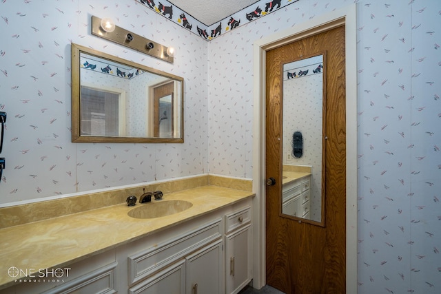 bathroom featuring vanity and a textured ceiling