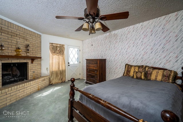 carpeted bedroom with a textured ceiling, ceiling fan, and a fireplace