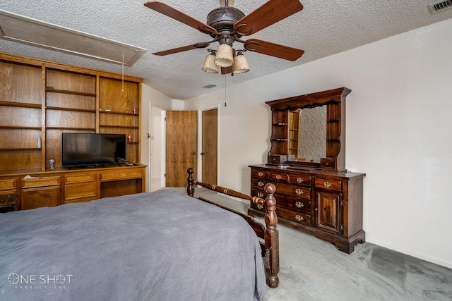 carpeted bedroom with ceiling fan and a textured ceiling