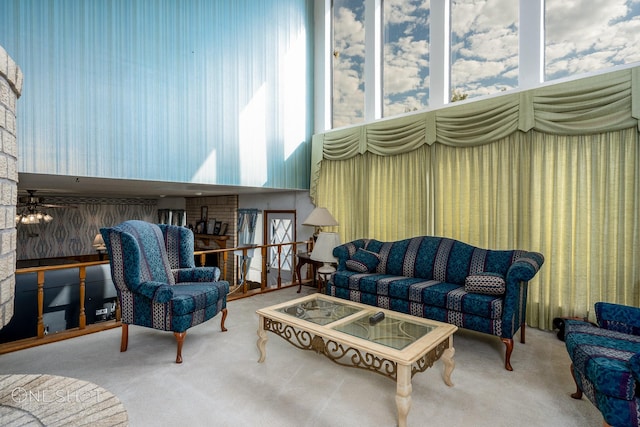 living area with ceiling fan and carpet floors