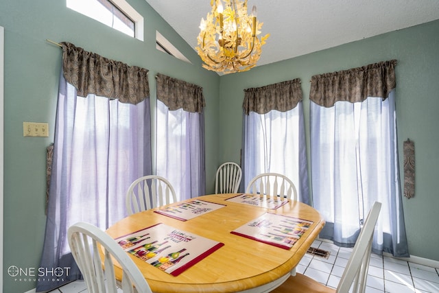 dining area featuring vaulted ceiling, a healthy amount of sunlight, light tile patterned floors, and an inviting chandelier