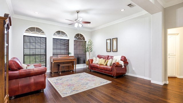 living room featuring dark hardwood / wood-style flooring, crown molding, and ceiling fan