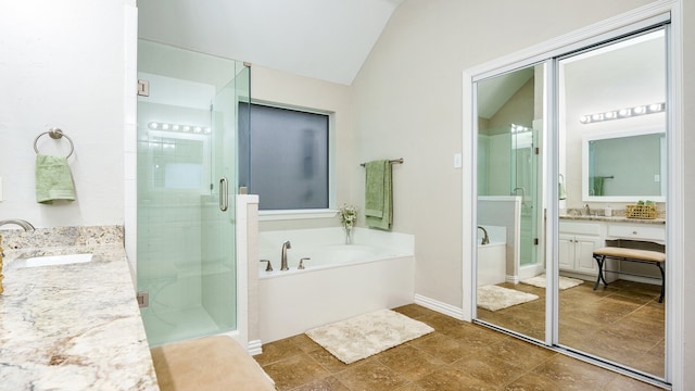 bathroom with lofted ceiling, vanity, and plus walk in shower