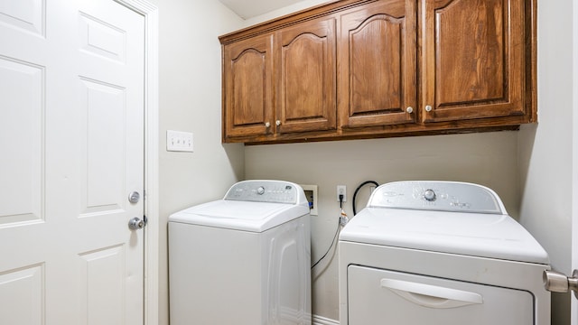 washroom featuring cabinets and washer and dryer