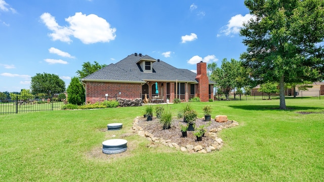 rear view of property featuring a yard