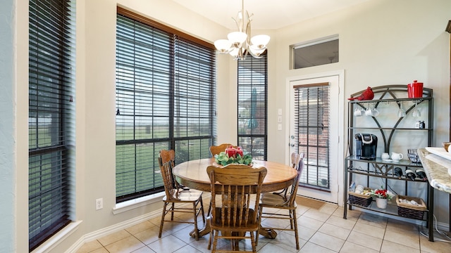 dining space with light tile patterned flooring and a notable chandelier