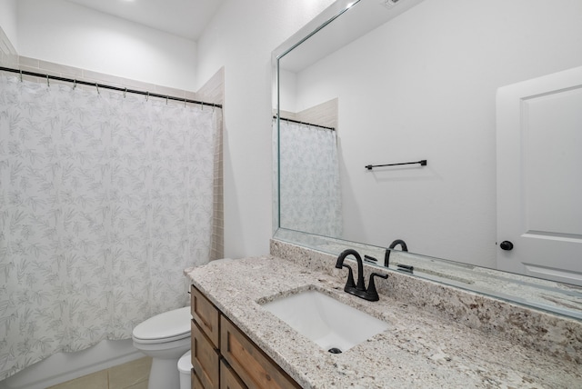 bathroom featuring tile patterned floors, vanity, toilet, and walk in shower