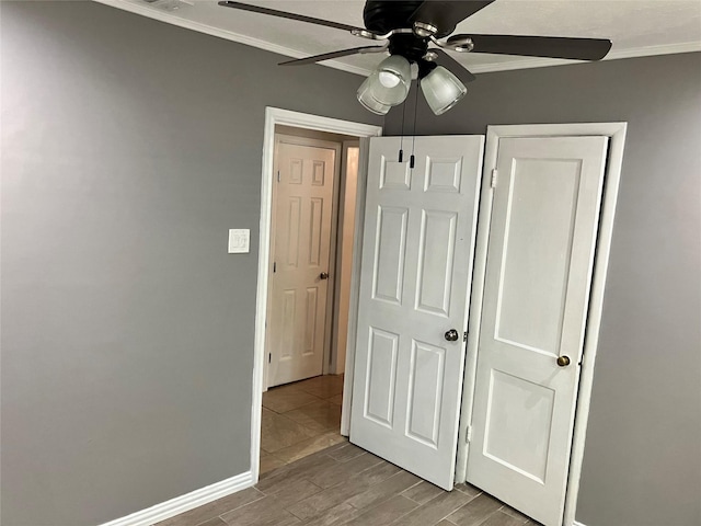 unfurnished bedroom with ceiling fan, ornamental molding, and light wood-type flooring