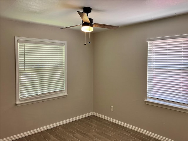 spare room featuring dark hardwood / wood-style floors and ceiling fan