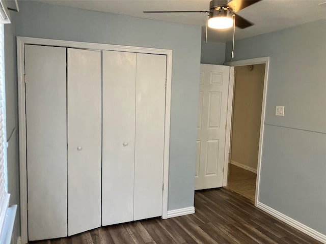 unfurnished bedroom with dark hardwood / wood-style floors, a closet, and ceiling fan