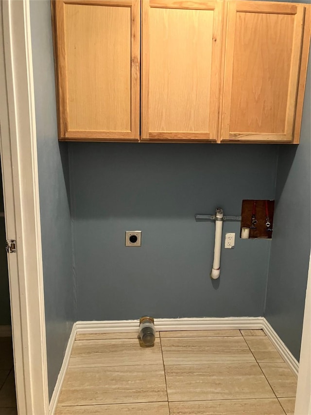 laundry room featuring cabinets and hookup for an electric dryer