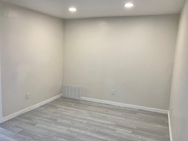 unfurnished room with light hardwood / wood-style floors