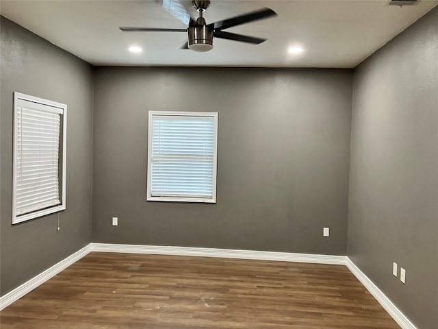 empty room with hardwood / wood-style flooring and ceiling fan