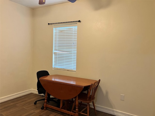 home office with dark wood-type flooring and ceiling fan