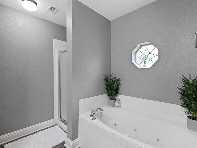 bathroom with wood-type flooring and separate shower and tub