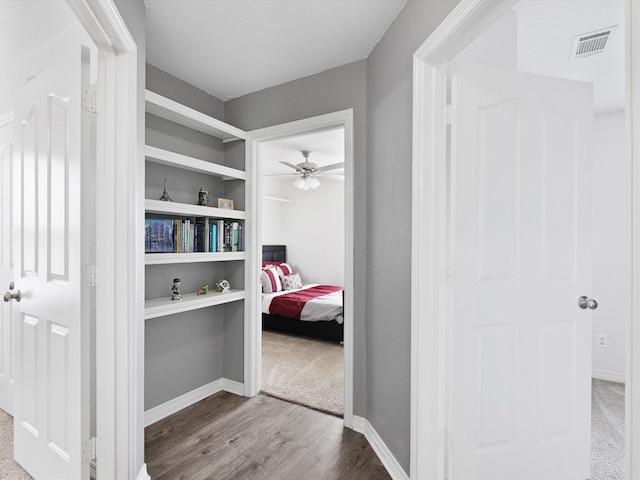 hall with hardwood / wood-style floors