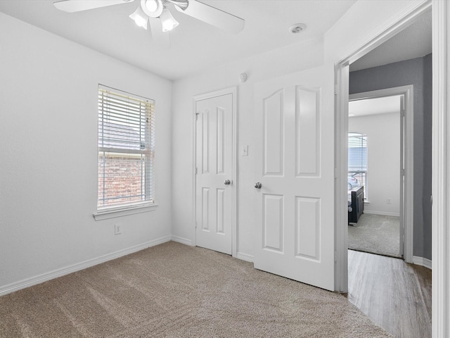 unfurnished bedroom with ceiling fan and light colored carpet