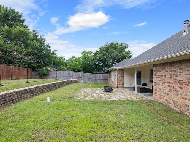 view of yard featuring a fire pit and a patio