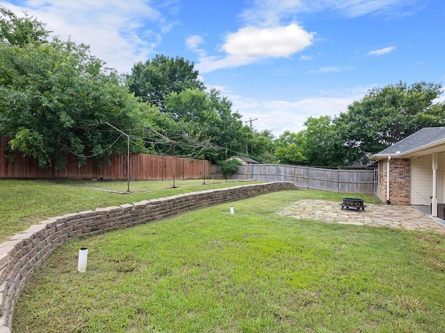 view of yard with a fire pit