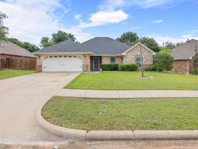 single story home featuring a garage and a front yard