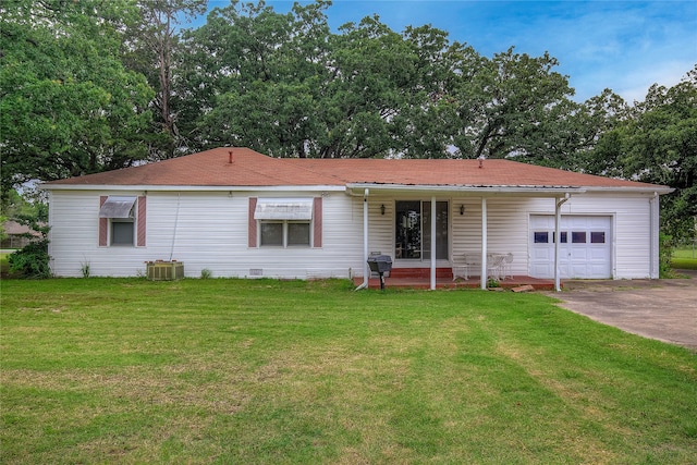 ranch-style house featuring a porch, a garage, and a front lawn