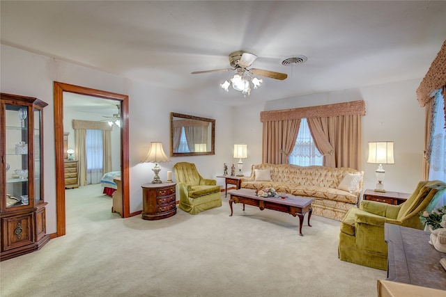 carpeted living room featuring ceiling fan