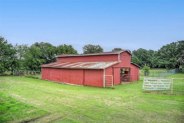 view of shed / structure with a rural view and a yard