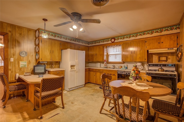 kitchen featuring decorative light fixtures, white appliances, ceiling fan, and light tile floors