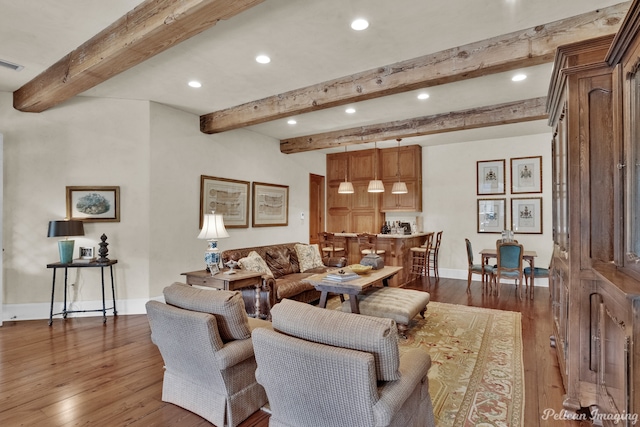 living room featuring wood-type flooring and beam ceiling