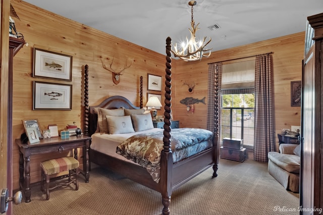 carpeted bedroom featuring wooden walls and a chandelier