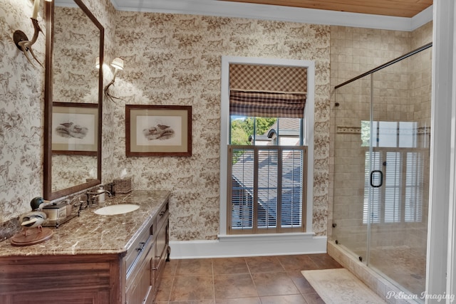 bathroom featuring tile floors, ornamental molding, an enclosed shower, and vanity