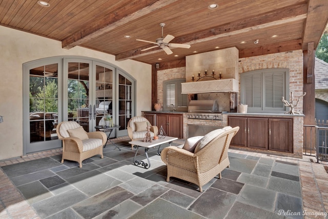 view of terrace with a grill, an outdoor kitchen, and ceiling fan