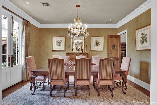 dining room with a wealth of natural light, a chandelier, hardwood / wood-style flooring, and ornamental molding