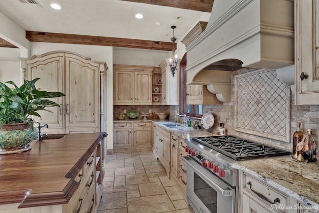 kitchen with light stone countertops, tasteful backsplash, designer range, light tile flooring, and pendant lighting