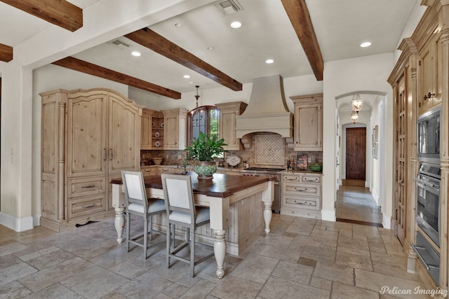 kitchen featuring appliances with stainless steel finishes, backsplash, light tile flooring, and custom exhaust hood