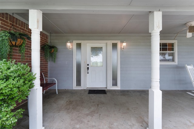 entrance to property featuring ceiling fan